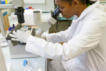 TRAIN4EU+ - a researcher looking into a microscope TRAIN4EU+ - a researcher looking into a microscope